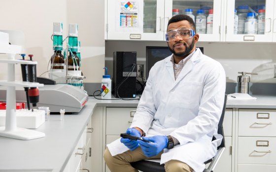 Dr. Monday Uchenna Okoronkwo sitting in a chemistry lab, wearing safety gear