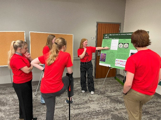 FYRE students look at poster. 