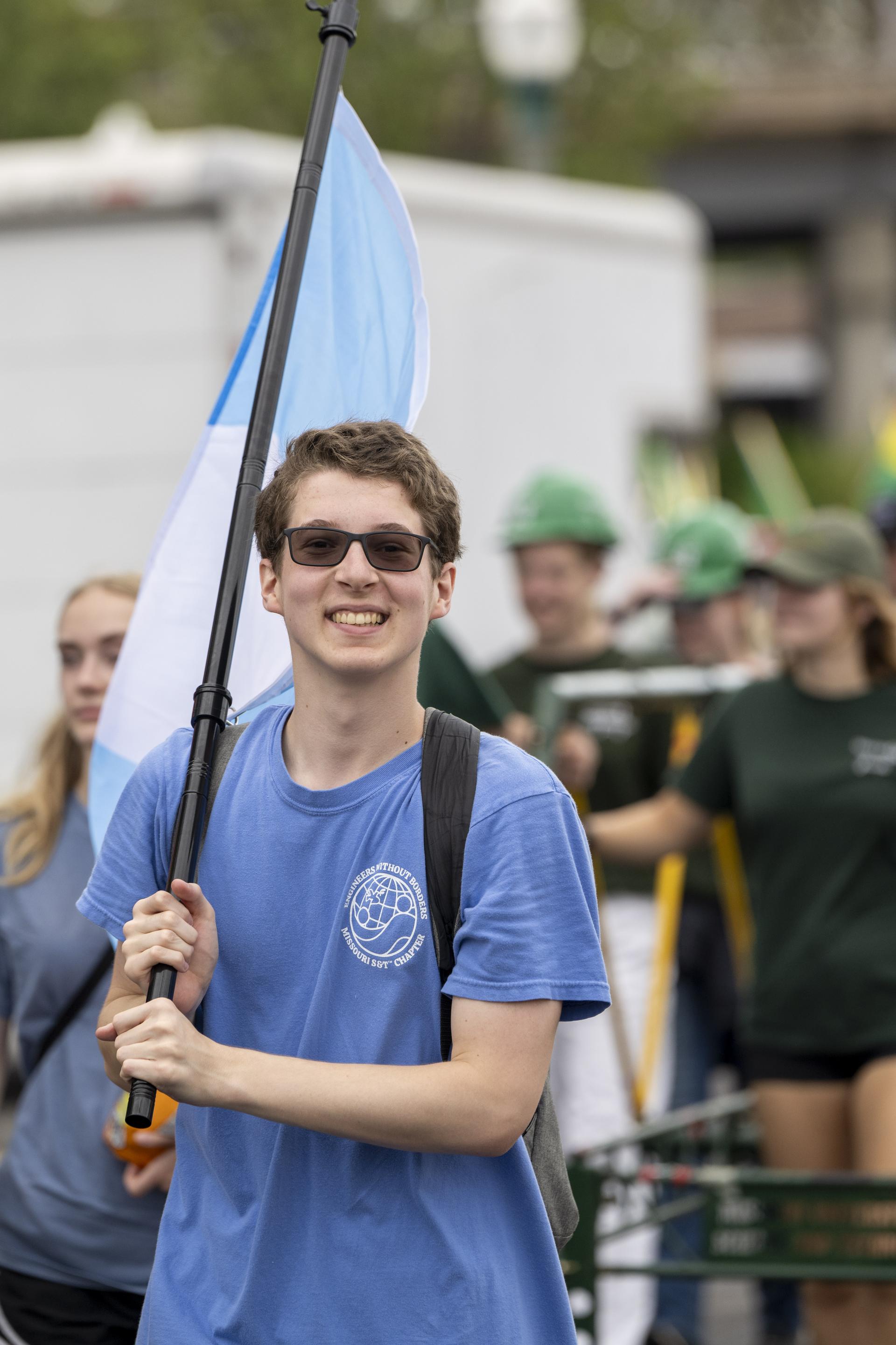 A Missouri S&T student holding a flag at the Celebration Of Nations Parade.
