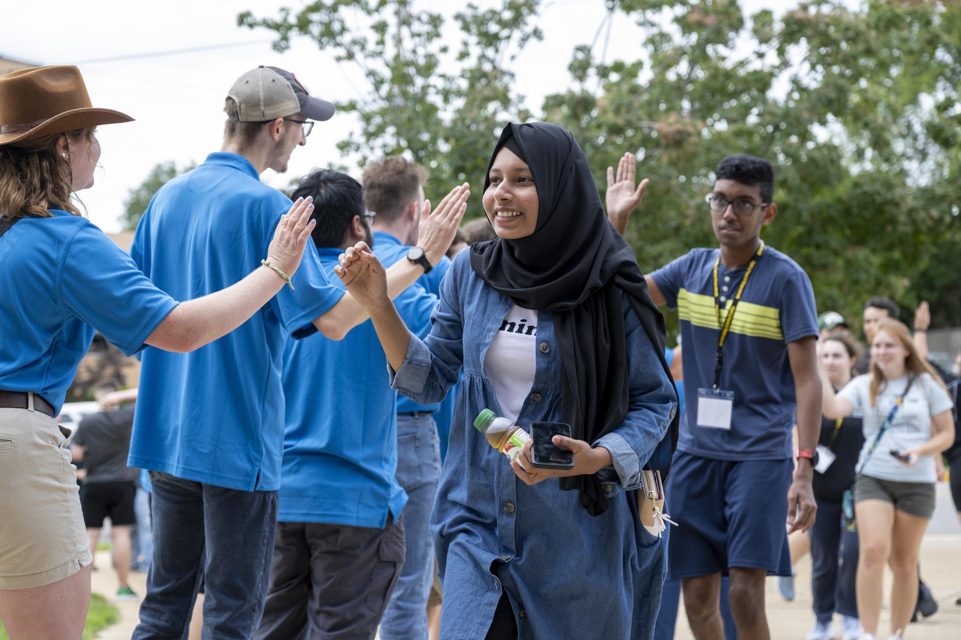 Students are welcomed as they arrive to convocation 