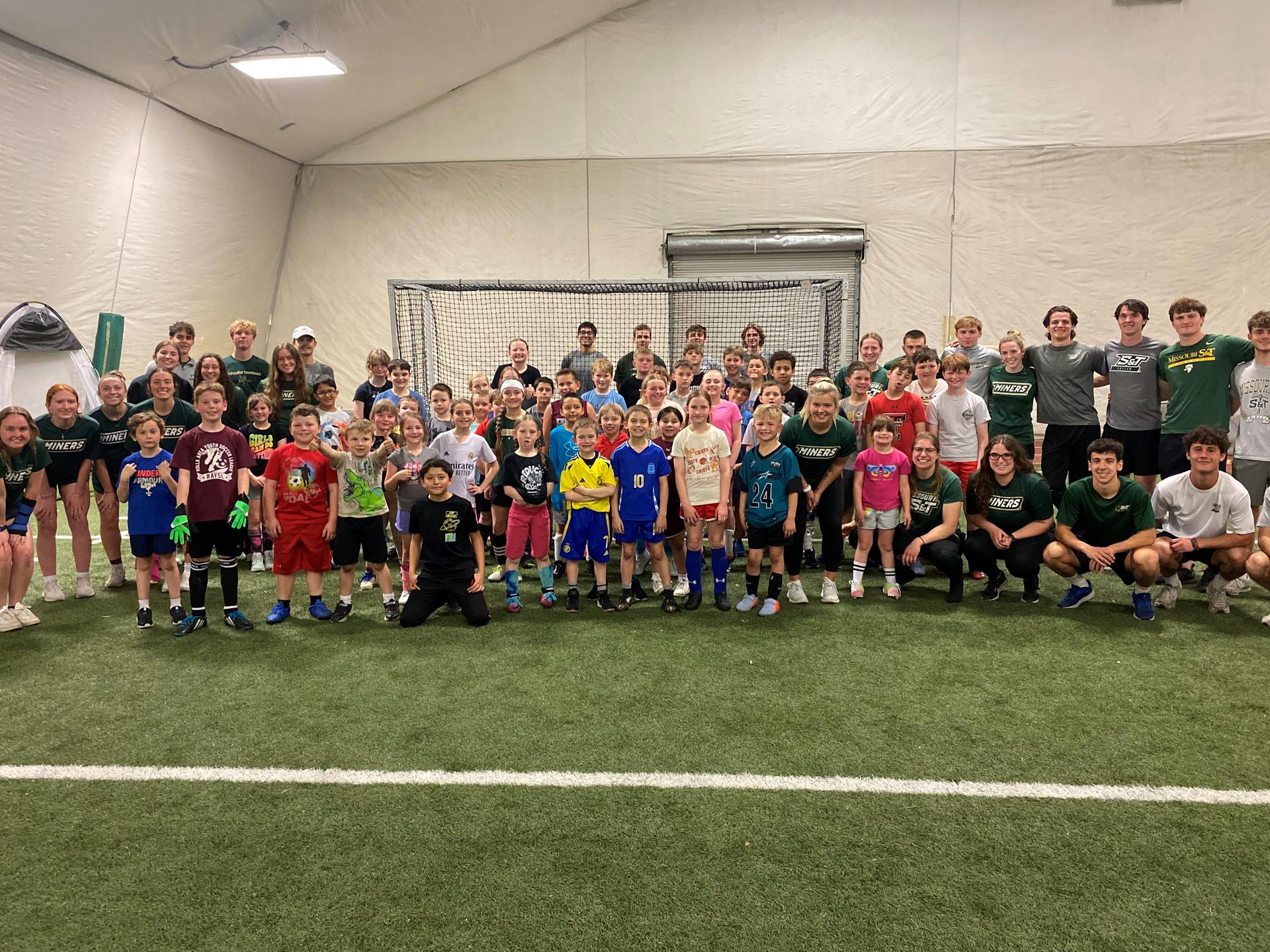 Group photo of young students playing soccer. 