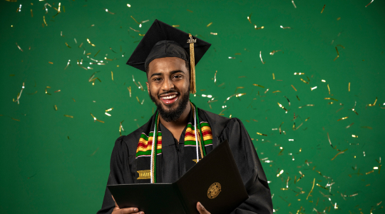 Abdu Ibrahim, recent graduate in Engineering Management, poses at S&T's graduation photo booth.