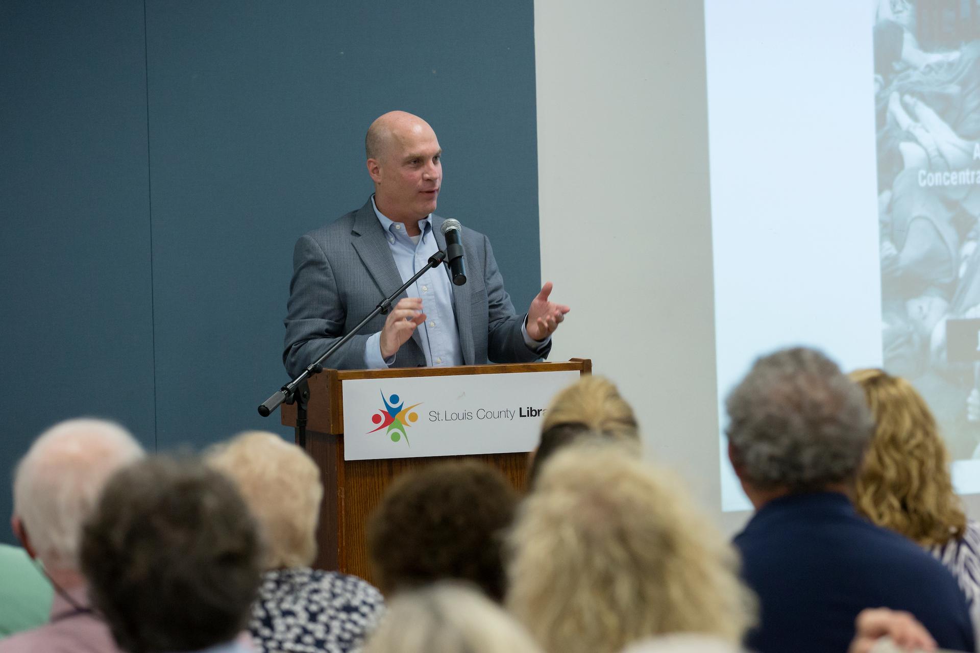 Dr. McManus presenting at a public talk. 