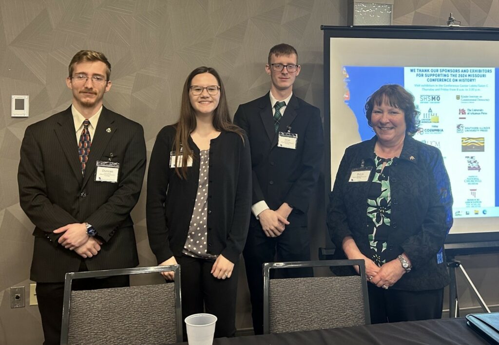 Three students on panel presentation. 