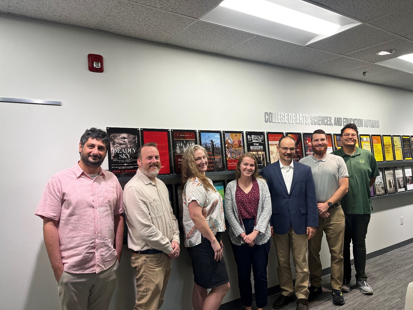 Seven new faculty members in a group photo. 