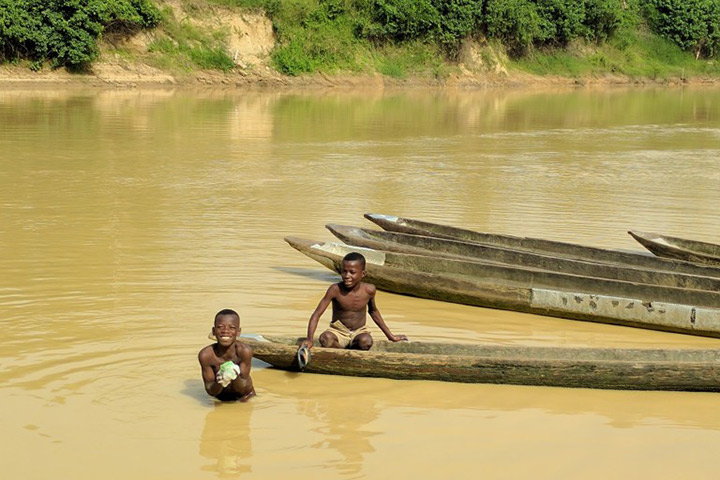 Two boys swim in the Tano River near Ghana’s western border with Ivory Coast. Contamination from artisanal mining has rendered the river’s water unfit for human consumption.